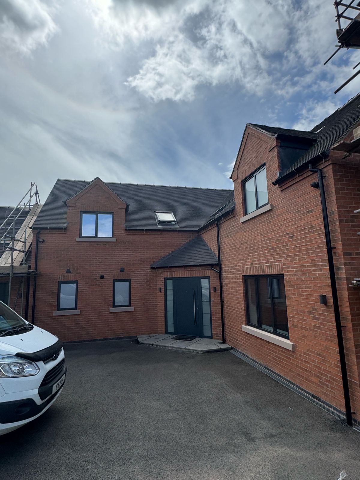 Front entrance elevation — clean sharp brickwork ready for handover