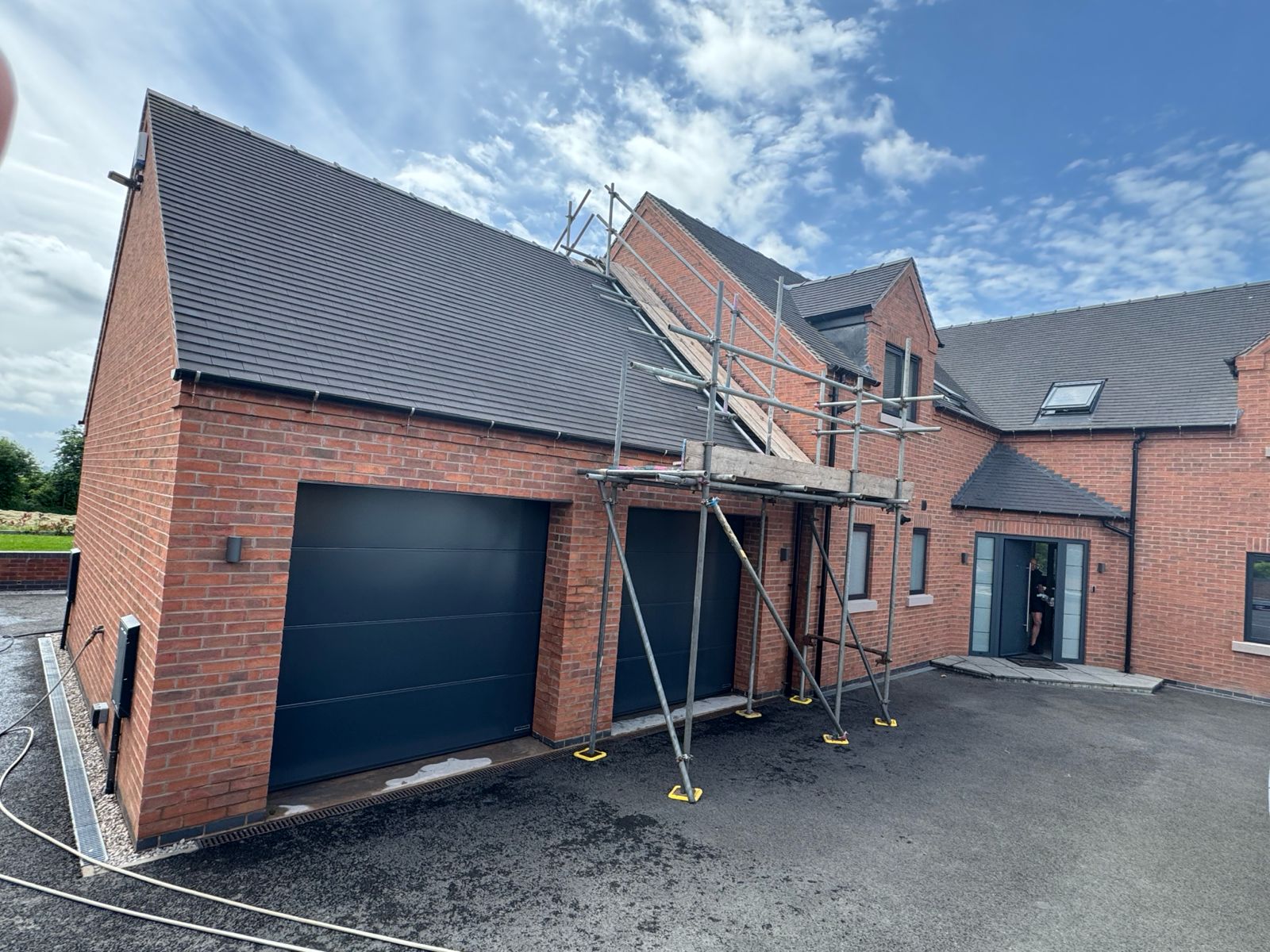 Front elevation with garage — repointing and cleaning in progress