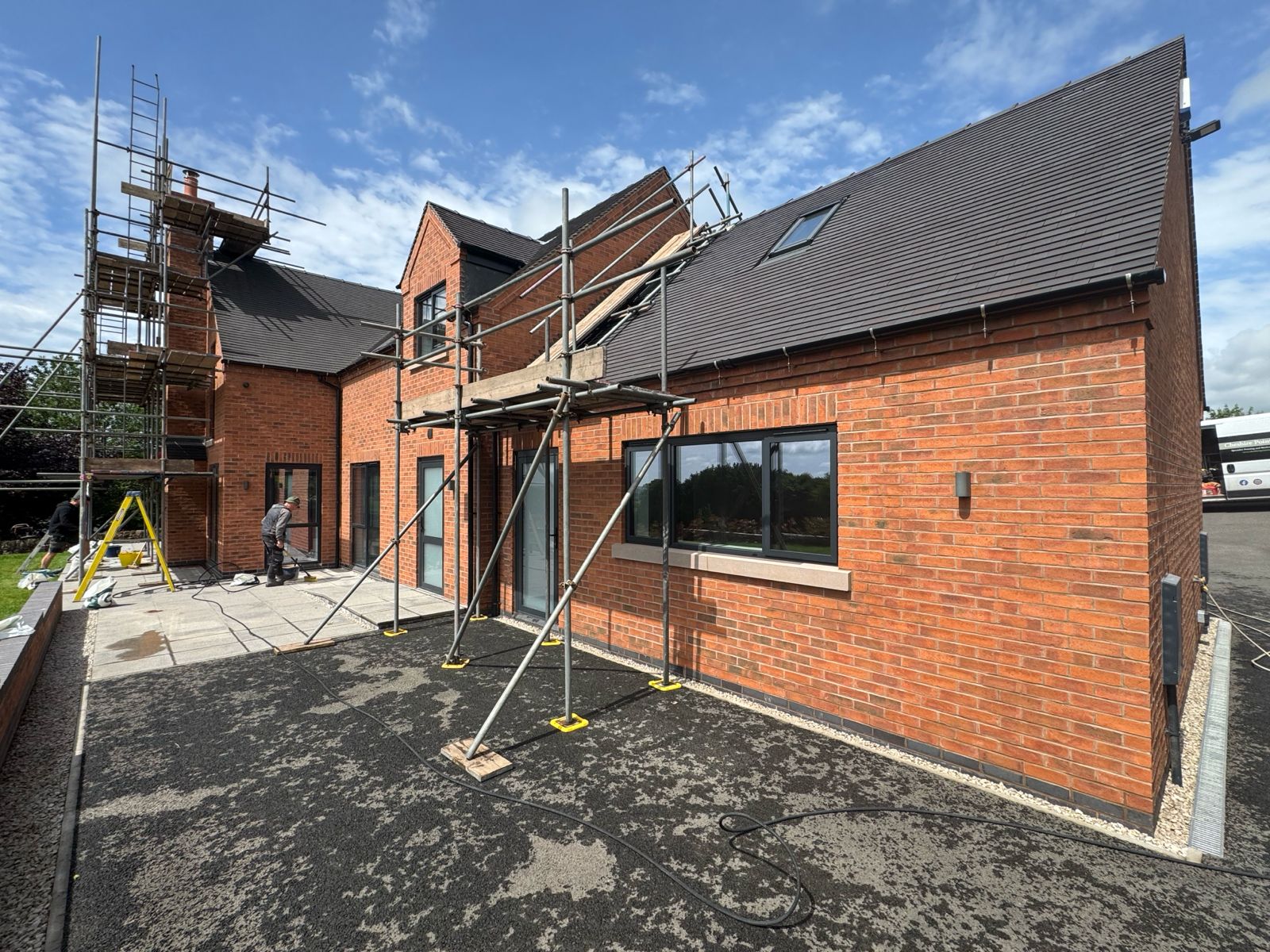 Rear elevation — team completing detailed finishing works