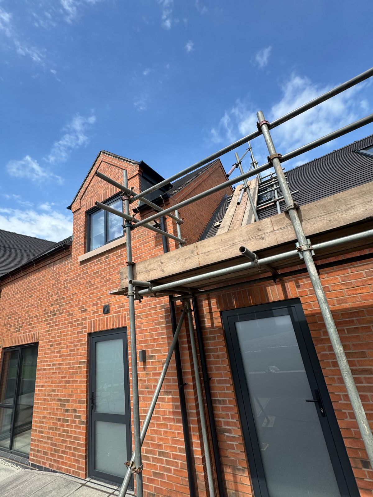 Upper scaffolding — careful detailing around roof line