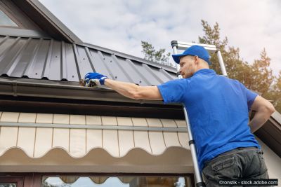 Un spécialiste nettoie les gouttières