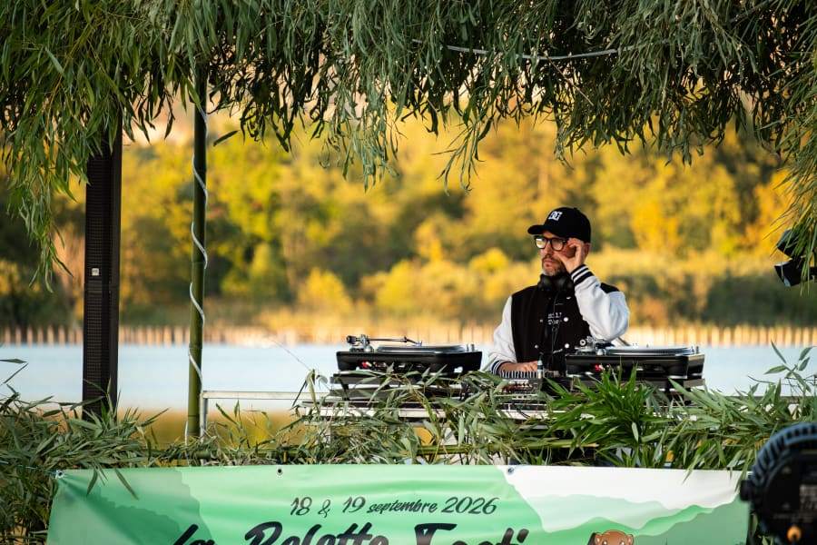 Scène du Belette Festival en plein air, au bord de l’eau, entourée d’arbres