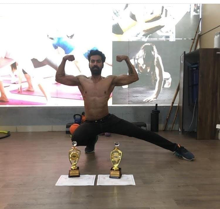 Competition trophies and physique pose