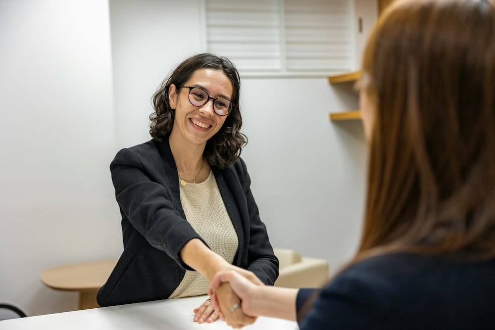 Women handshake with interviewer