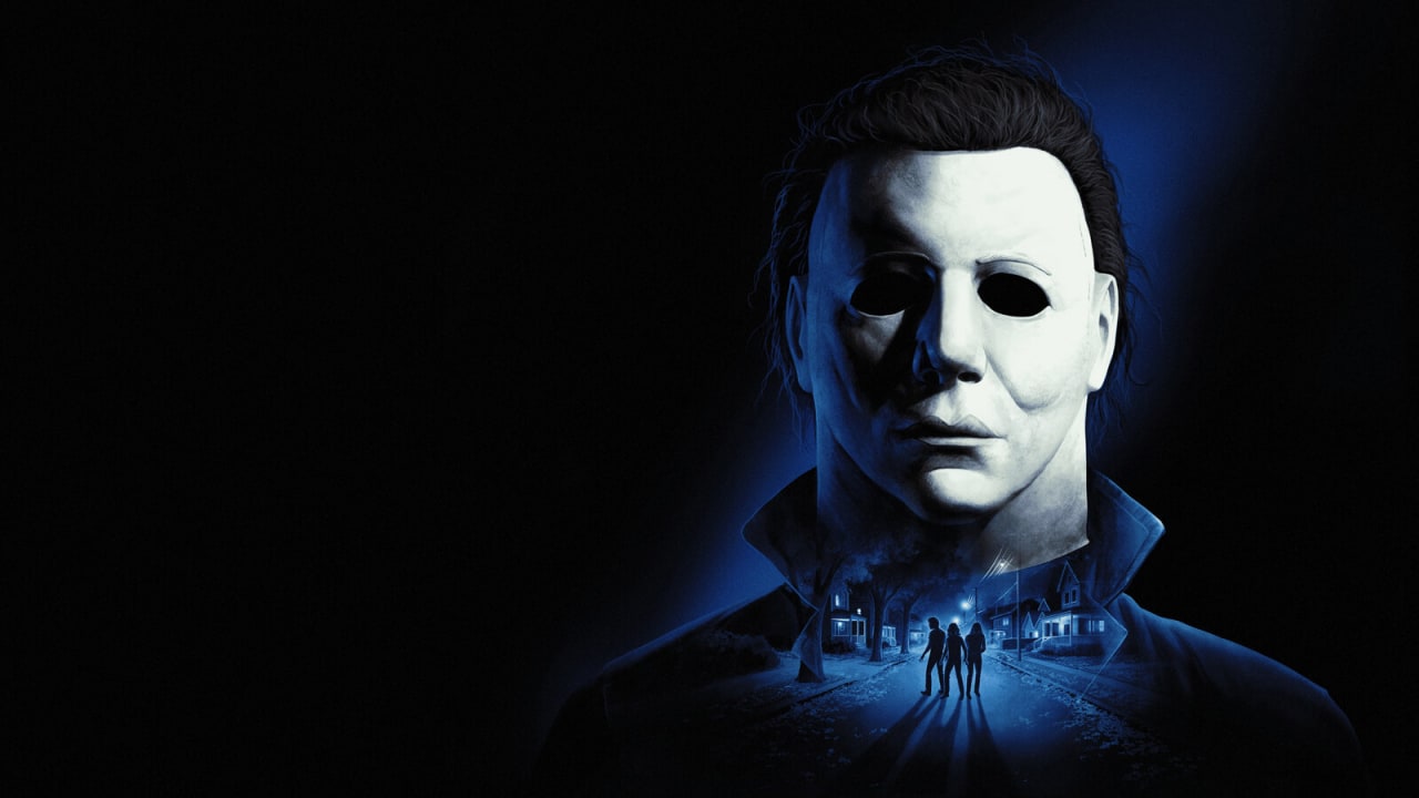 A máscara branca de Michael Myers sob luz azul, com uma rua de Haddonfield à noite desenhada na gola e três jovens caminhando por ela