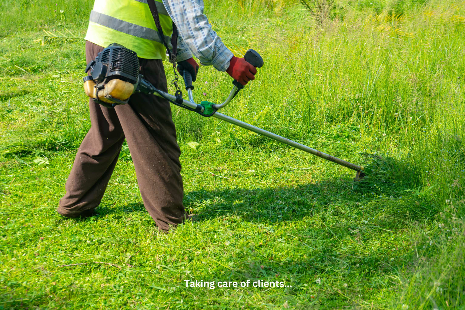 Landscaping business owner reviewing salary and financial data on a tablet next to a commercial truck with crew working in the background
