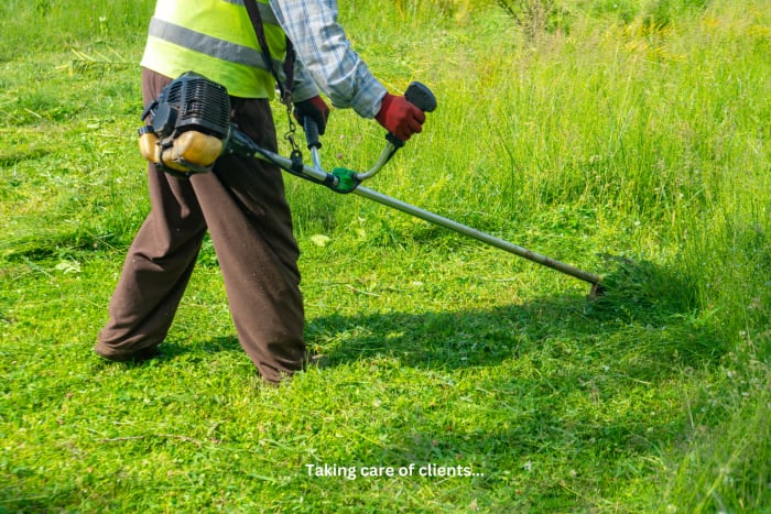 Landscaping business owner reviewing salary and financial data on a tablet next to a commercial truck with crew working in the background