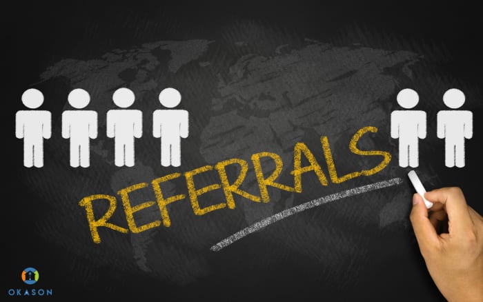 Landscaping contractor shaking hands with homeowner couple on a freshly landscaped front porch