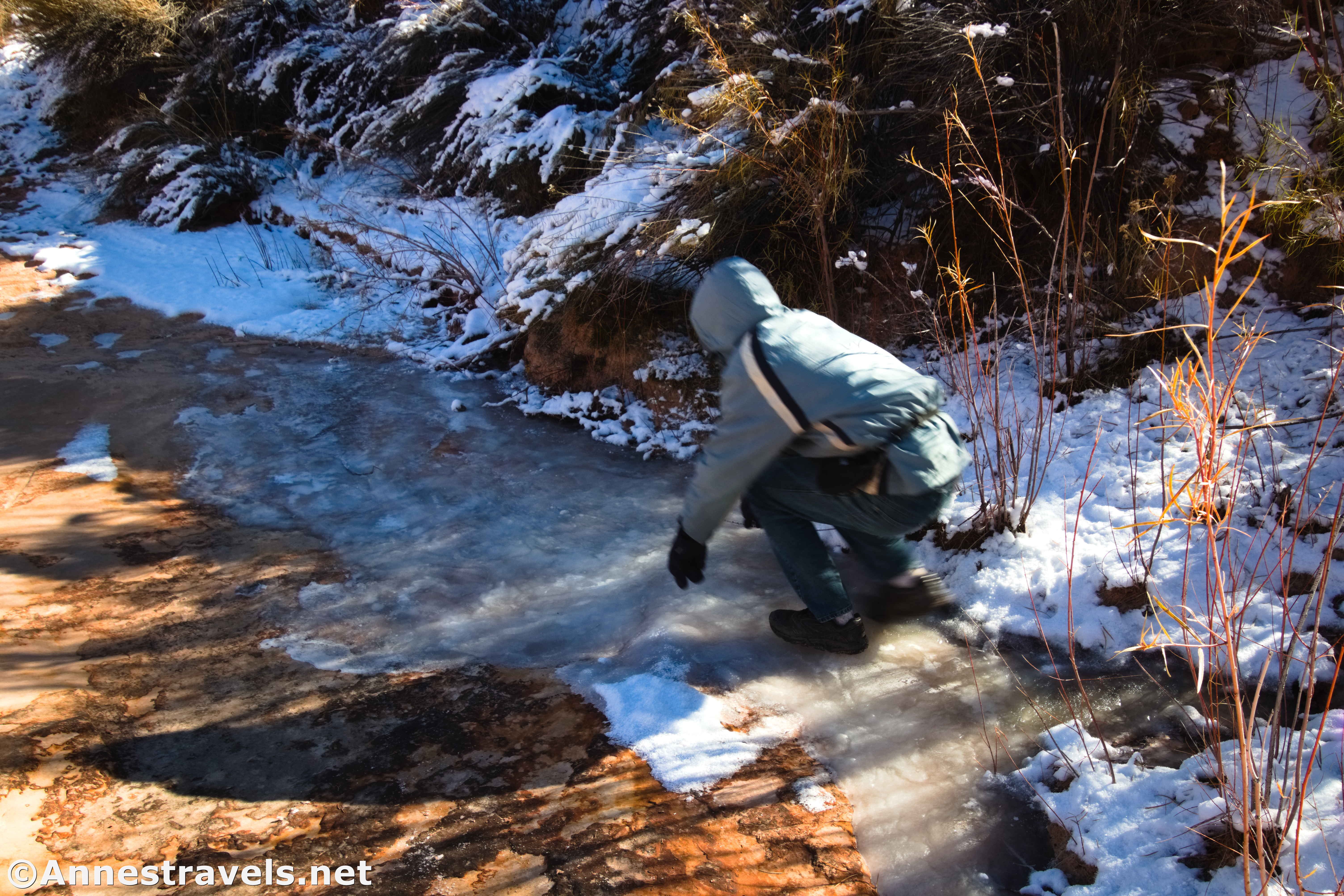 Sliding down the ice below French Spring, Maze District of Canyonlands National Park, Utah