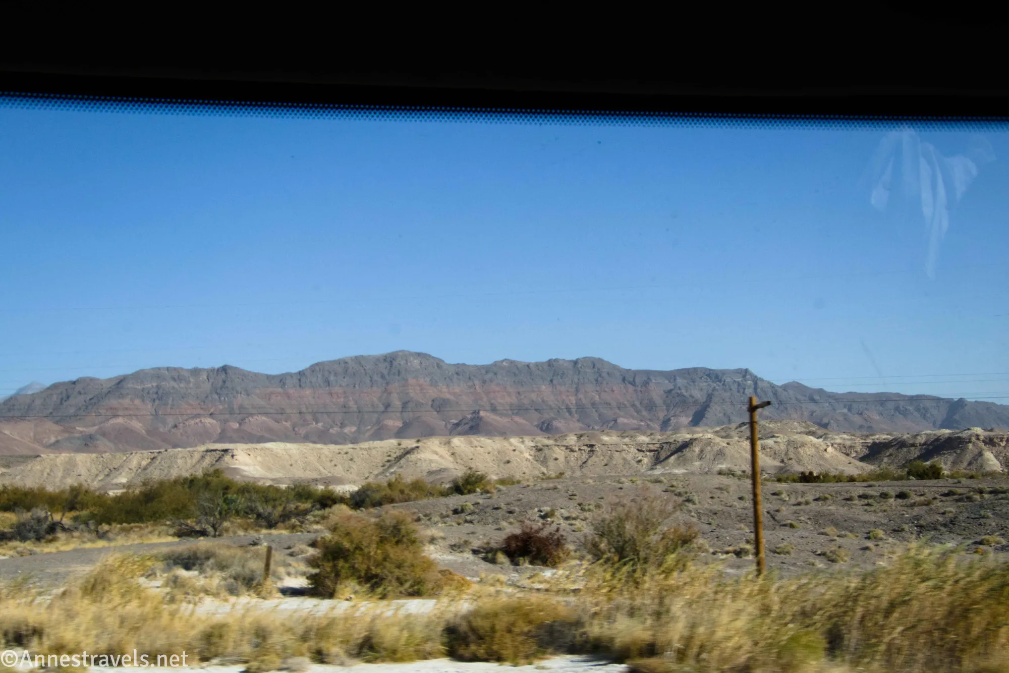 Desert mountains, badlands, and powerlines