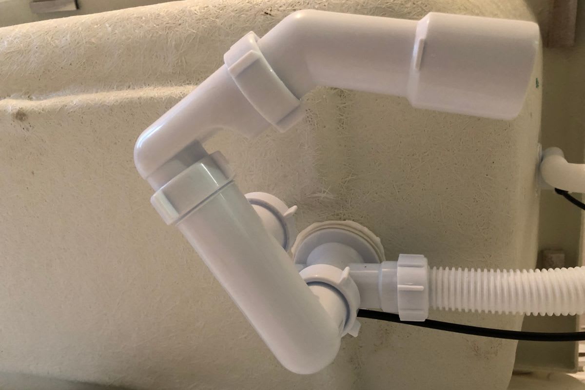 Der Siphon wird installiert, lange bevor die Wanne steht. Nur so kannst du die Aussparungen aus dem Wannenträger an der richtigen Stellen herausschneiden