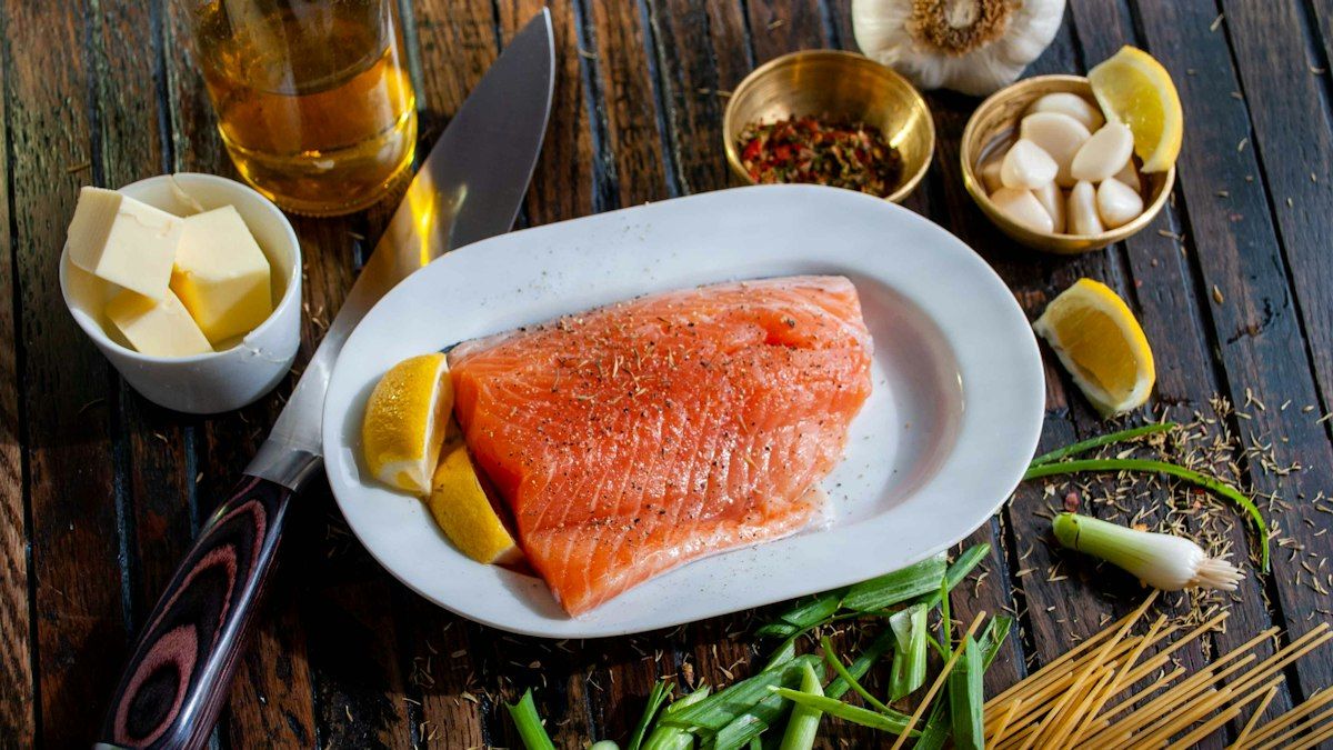 Seasoned fresh salmon fillets ready to be placed in the air fryer basket