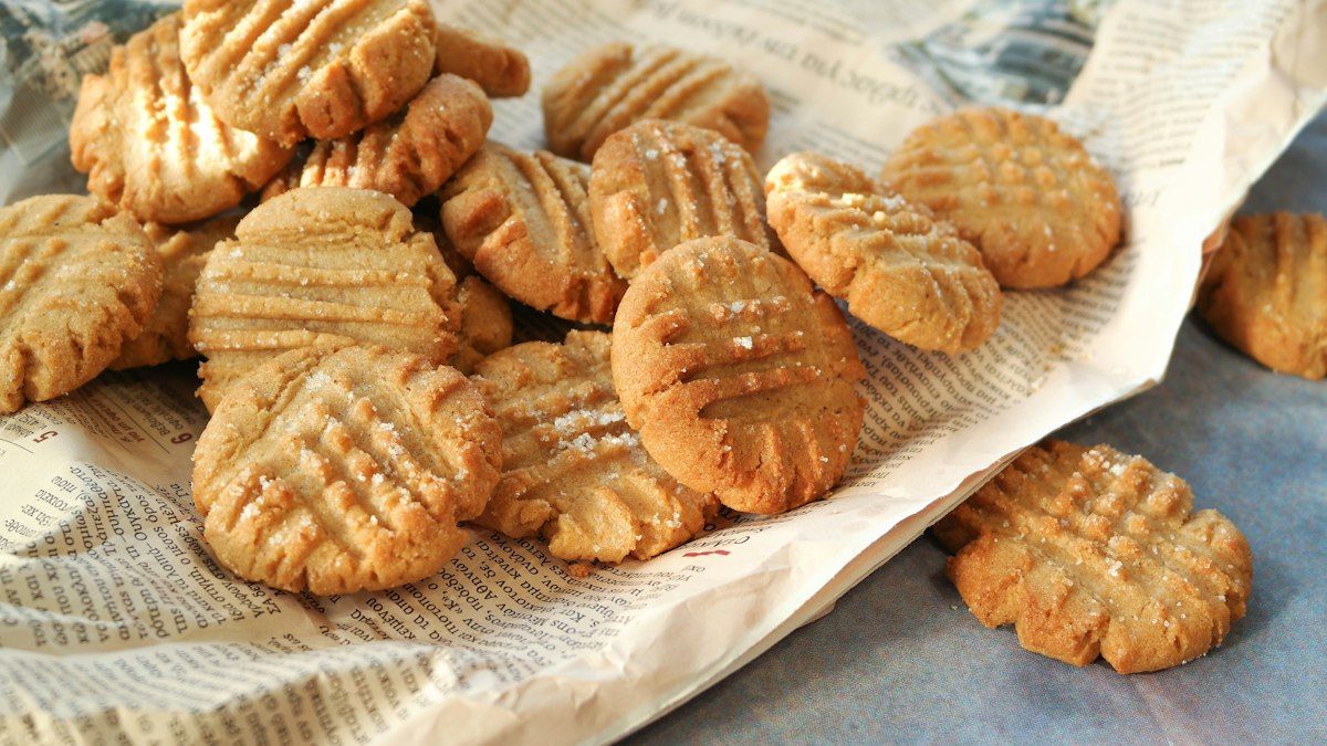 Freshly baked three ingredient peanut butter cookies cooling on parchment paper