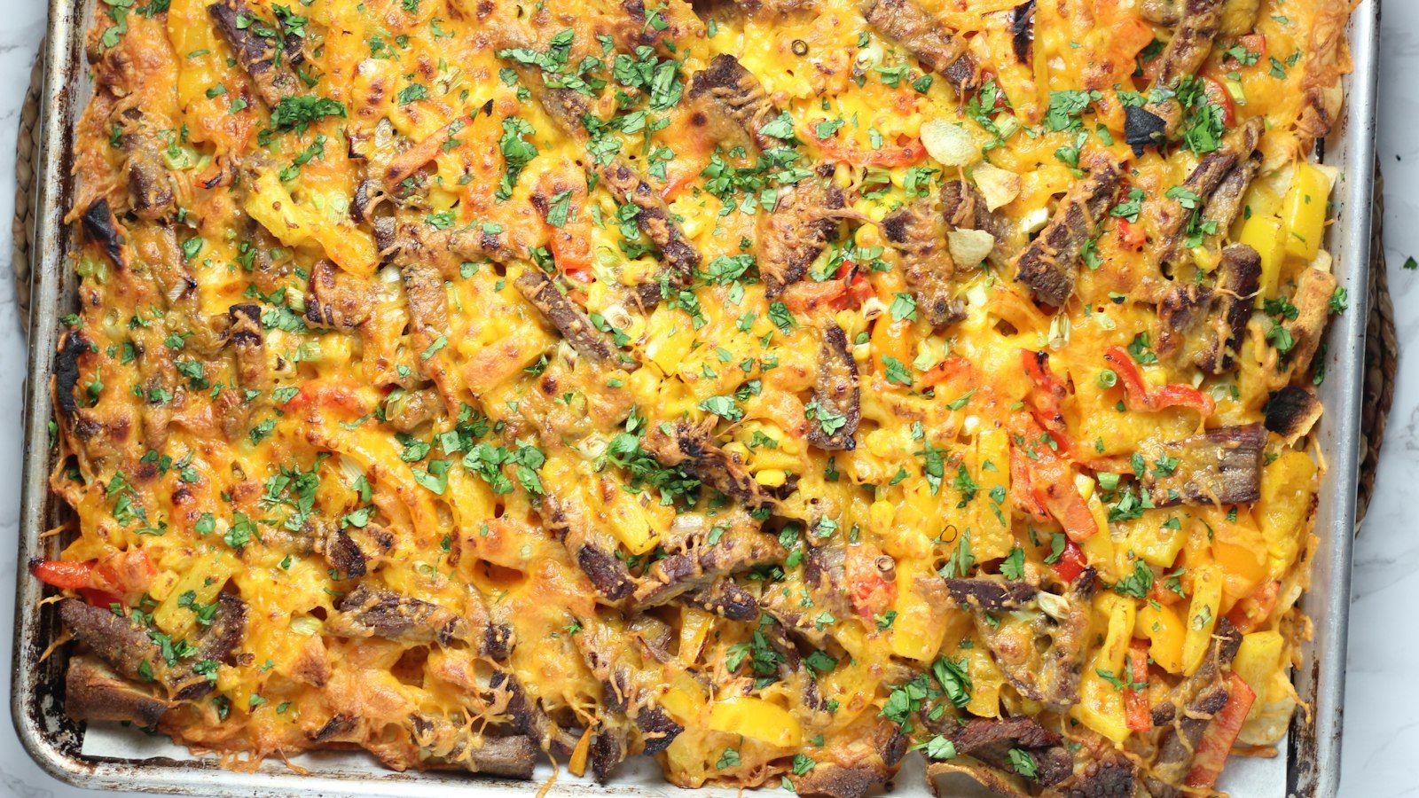 A freshly baked bubbling casserole with ground beef and sliced potatoes in a ceramic dish