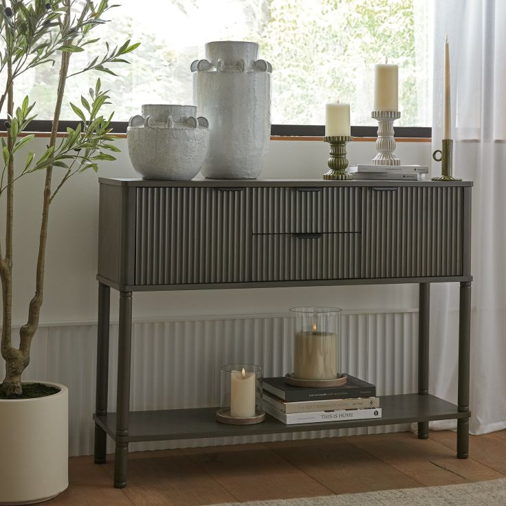Reed Fluted Charcoal Console Table with two drawers and two cupboards in a contemporary living room setting.