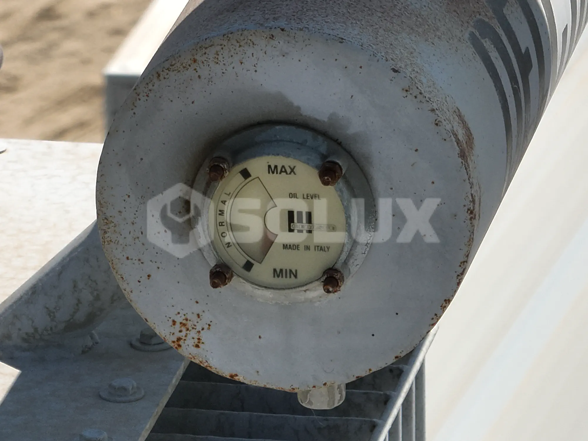 Visor de nivel de aceite dieléctrico de transformador ubicado en una subestación aérea con indicador por debajo del mínimo permisible