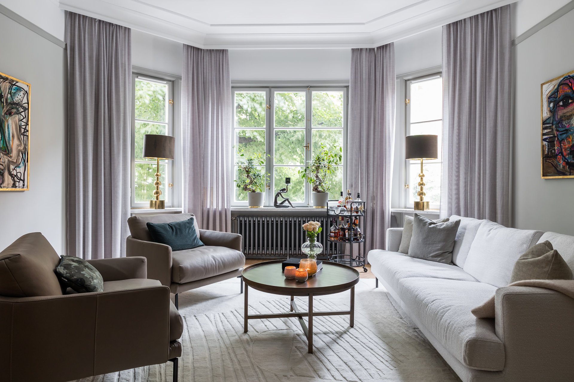 Charles Maison II social salon with bay window overlooking greenery