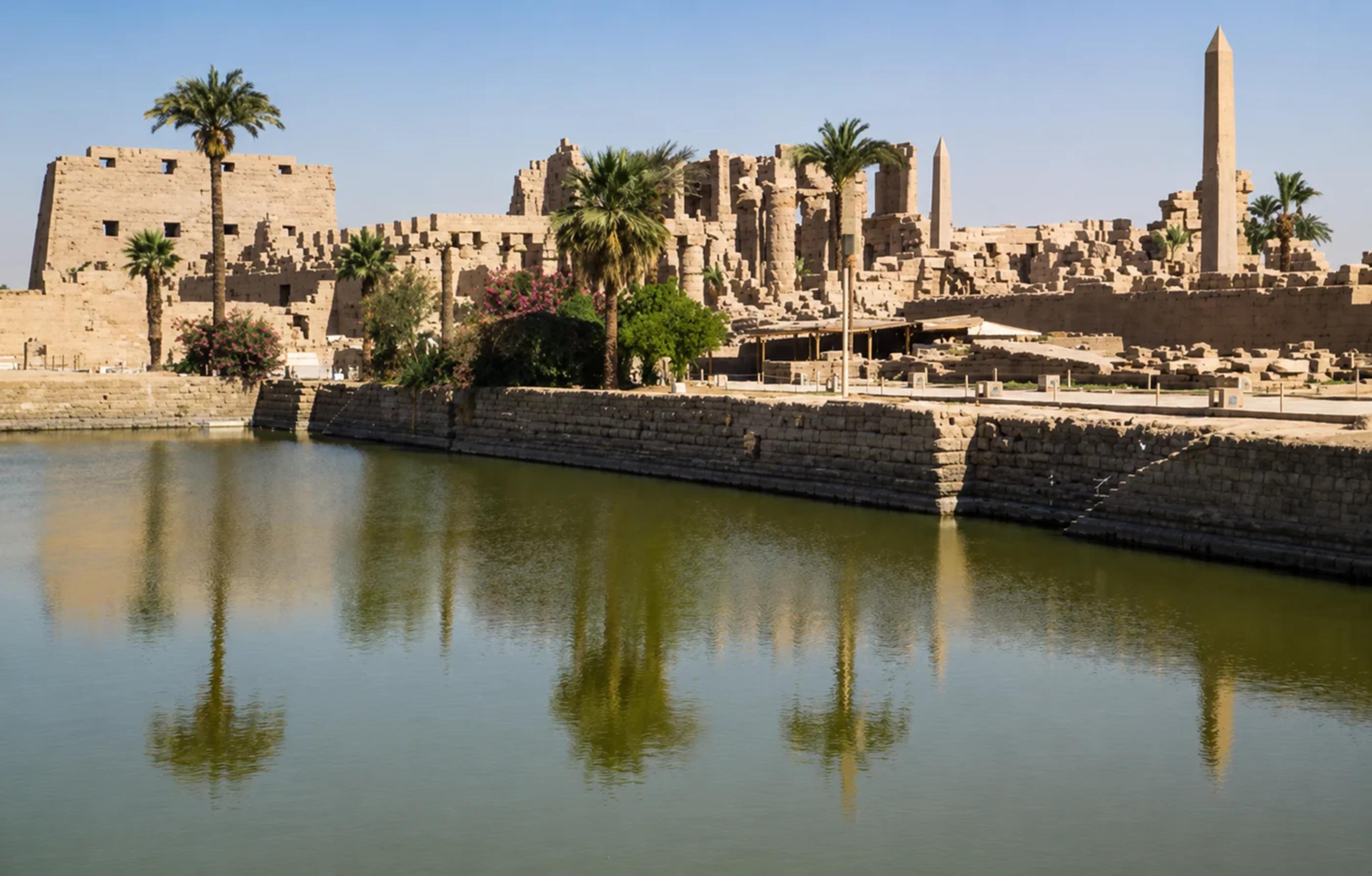 The sacred lake, looking south toward the avenue of ram-headed sphinxes. A pair of mallards on the water.