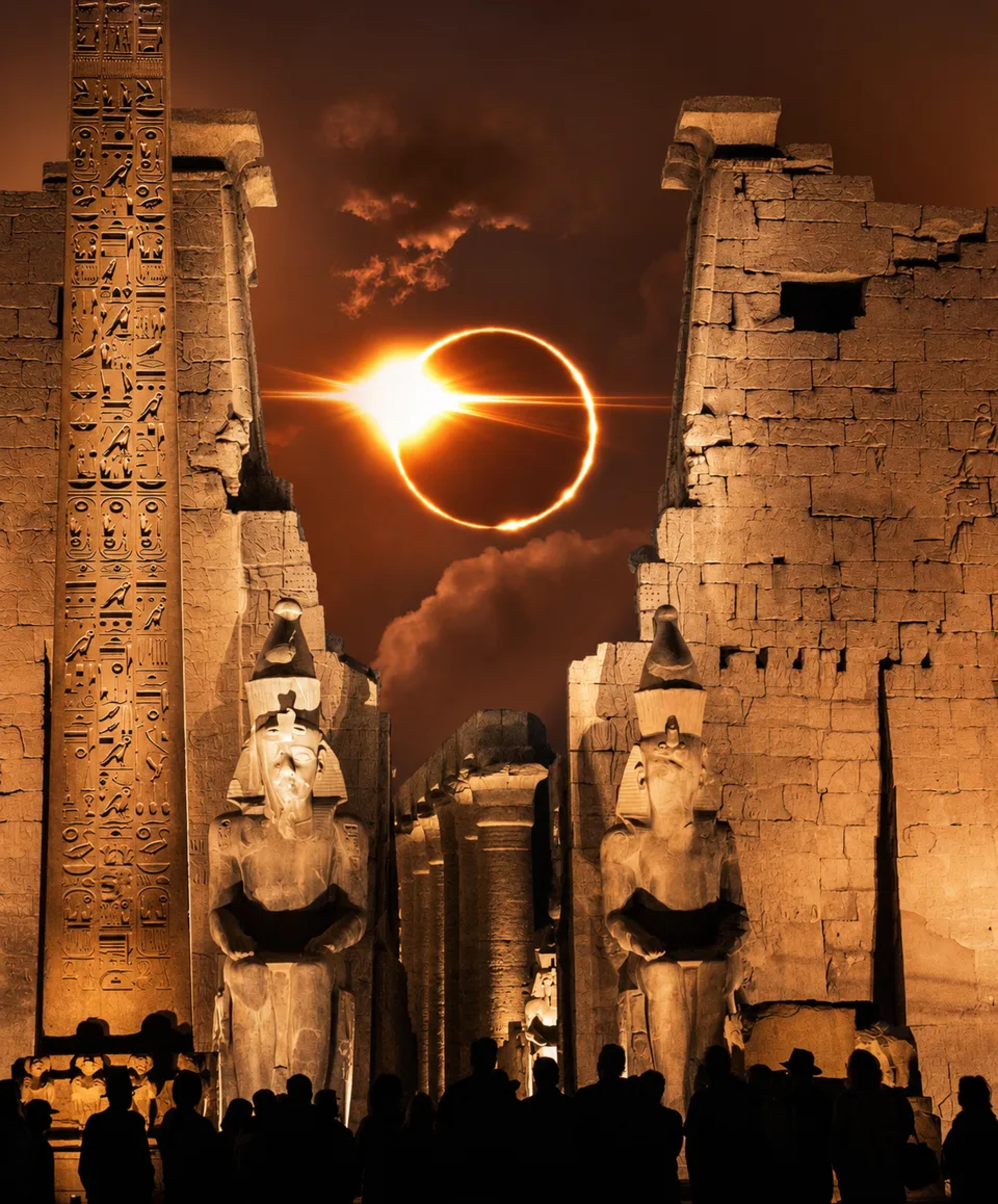 ancient Egyptian temple, temple ruins, Egyptian statues, hieroglyphic obelisk, solar eclipse, glowing ring of fire, orange sky, silhouetted visitors, dramatic night scene, Luxor-inspired architecture