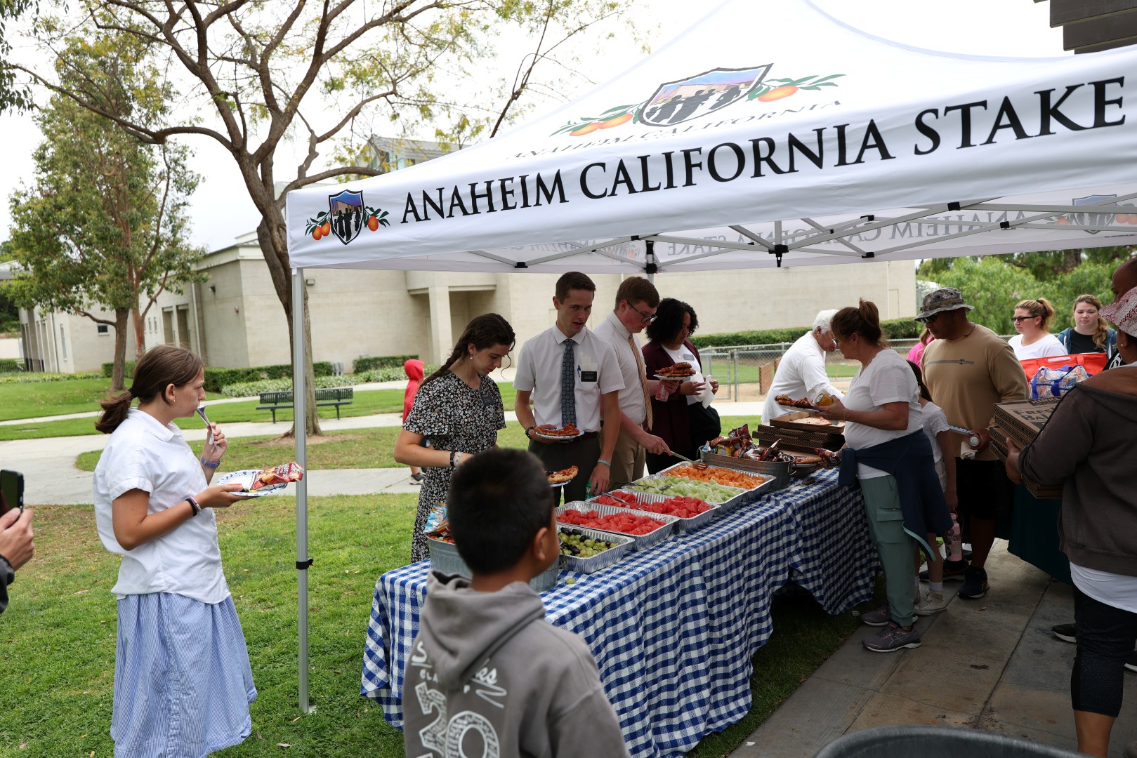 LDS Mormon Missionaries of The Church of Jesus Christ of Latter-day Saints serving food
