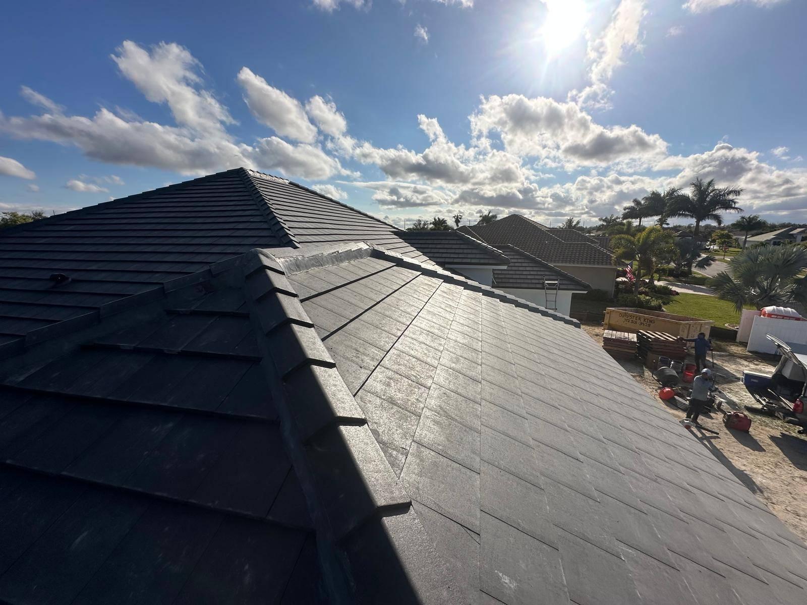 Professional roofing contractor inspecting a damaged asphalt shingle roof to determine if repair or replacement is needed