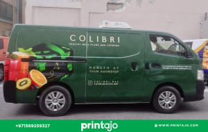 Full commercial van wrap for Colibri Catering Services featuring a dark green botanical pattern, fresh fruit imagery (kiwi, orange), and 'Health at Your Doorstep' slogan, designed by Printajo Dubai.