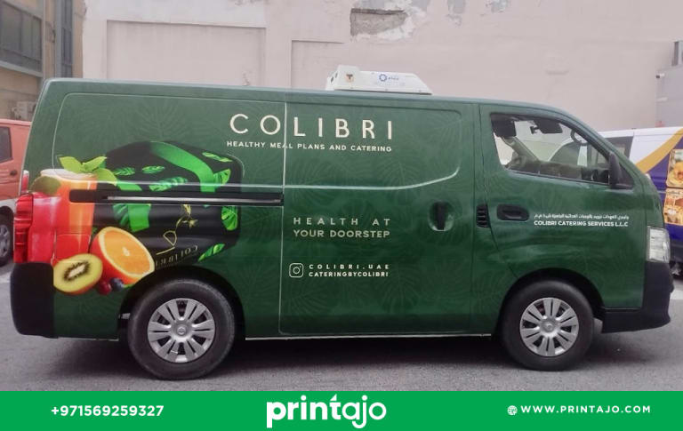 Full commercial van wrap for Colibri Catering Services featuring a dark green botanical pattern, fresh fruit imagery (kiwi, orange), and 'Health at Your Doorstep' slogan, designed by Printajo Dubai.
