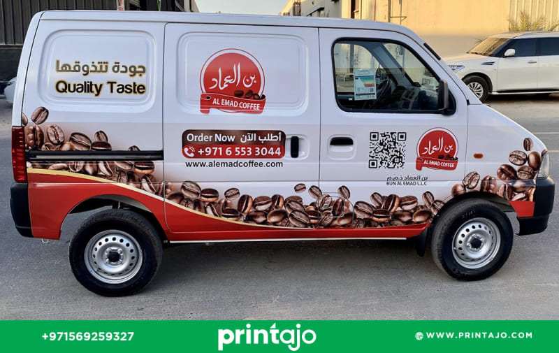 Delivery van branding for Al Emad Coffee in Sharjah. The design features a bottom wrap of roasted coffee beans, a bilingual 'Quality Taste' slogan, and a QR code for easy ordering. Vehicle graphics installed by Printajo.