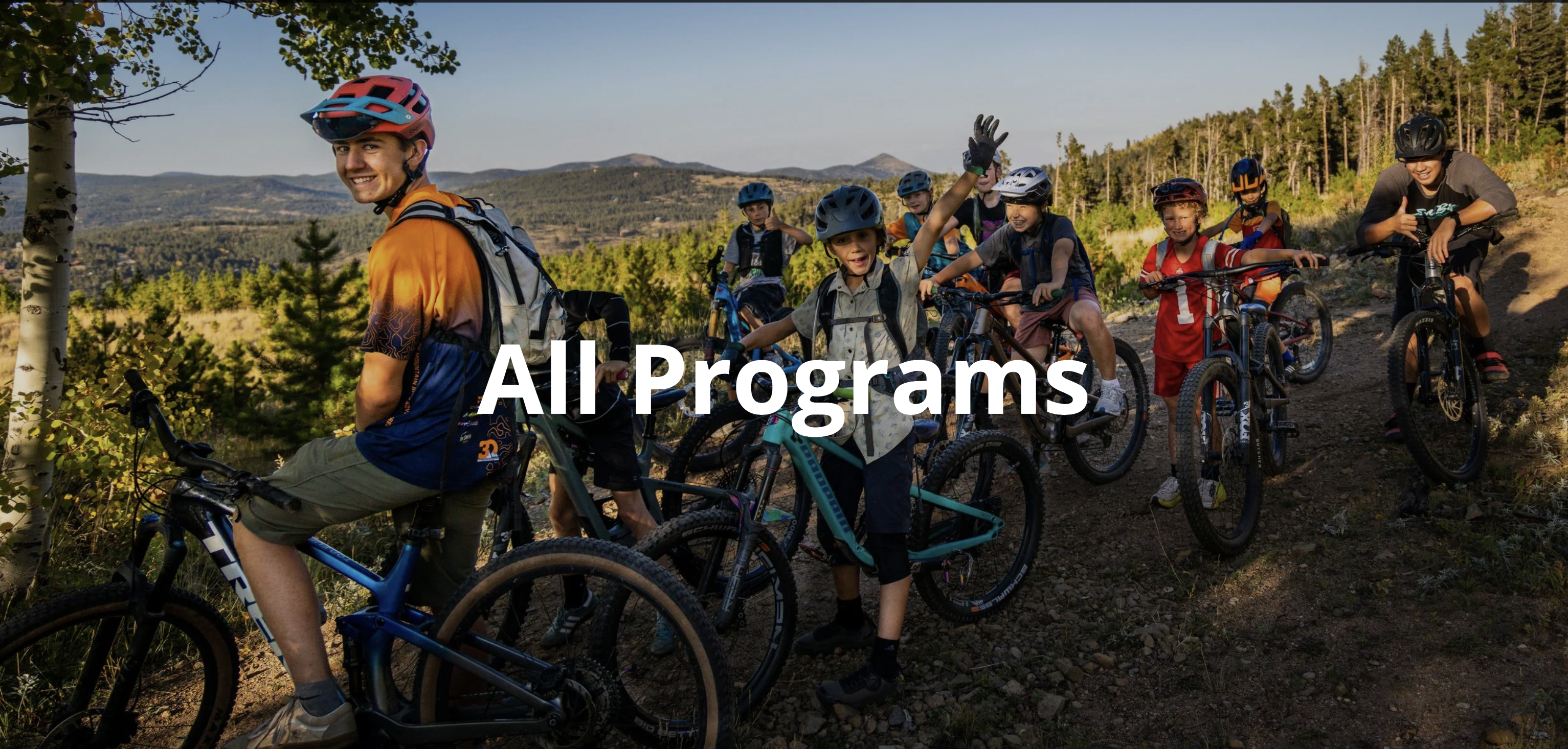 Young riders in helmets with mountain bikes