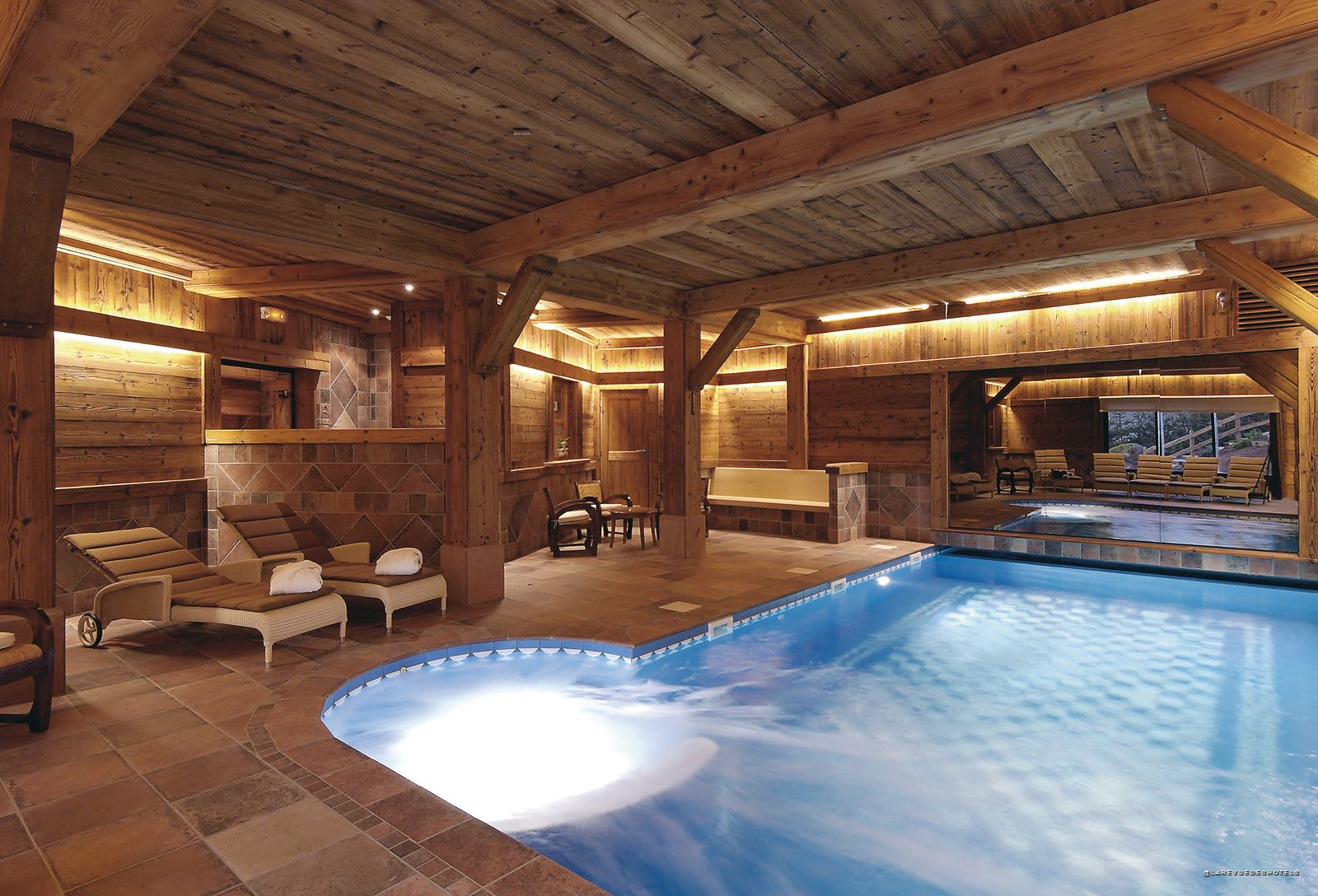 The indoor pool at Les Bas Rupts, under the chalet's wooden beams