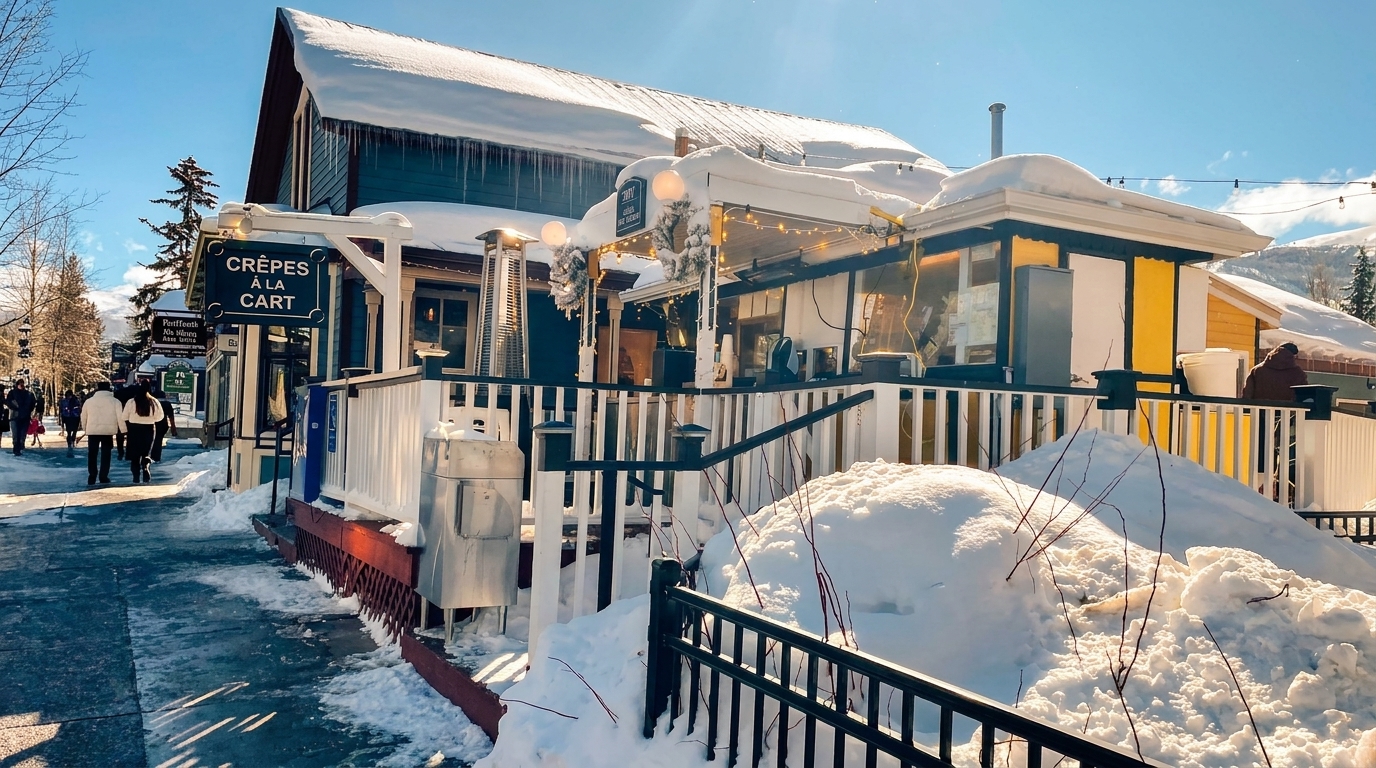 Crepes A La Cart restaurant exterior in winter, with snow-covered roofs and icicles.