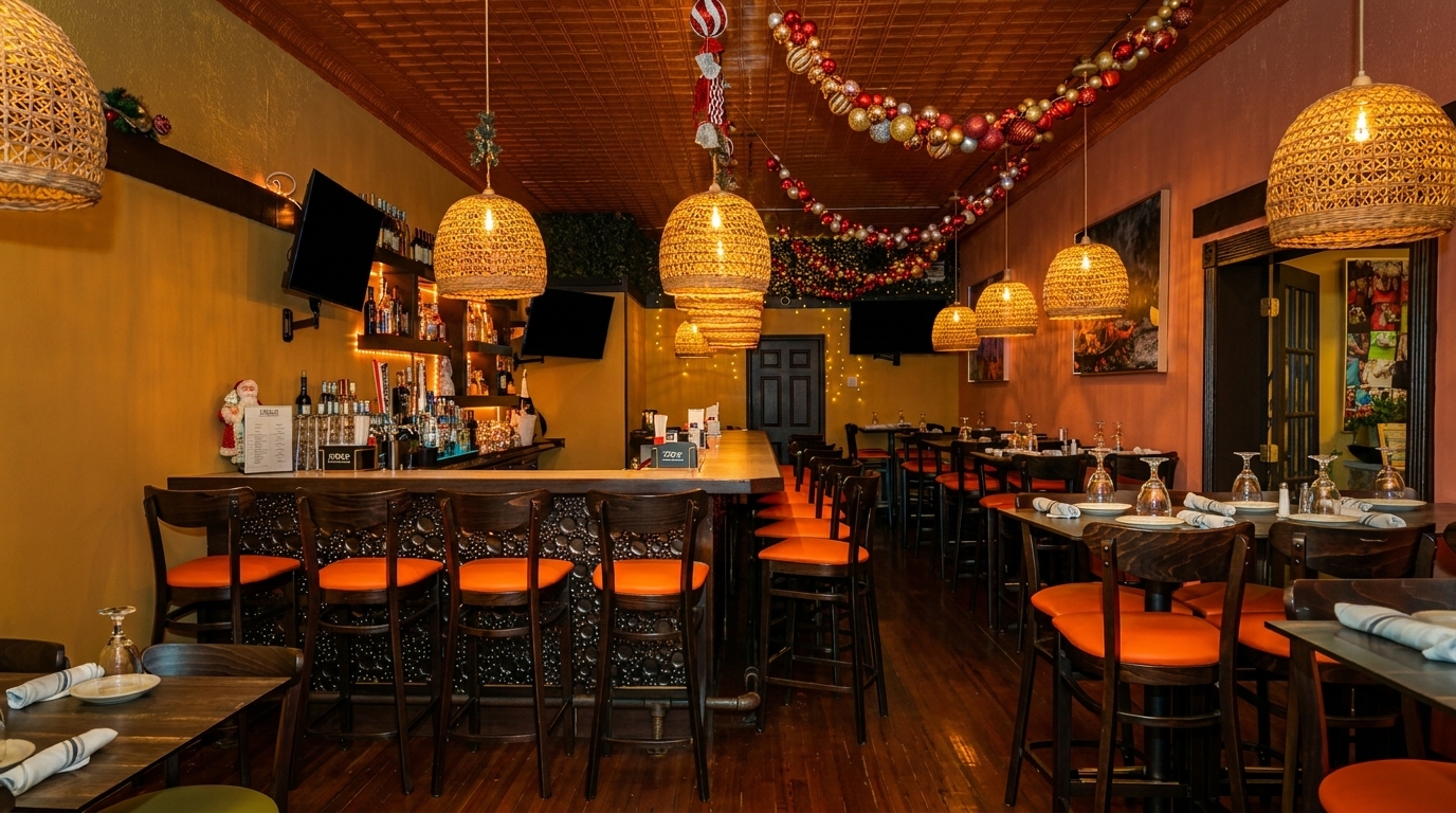 A festive restaurant interior with a long bar, dining tables, and holiday decorations.