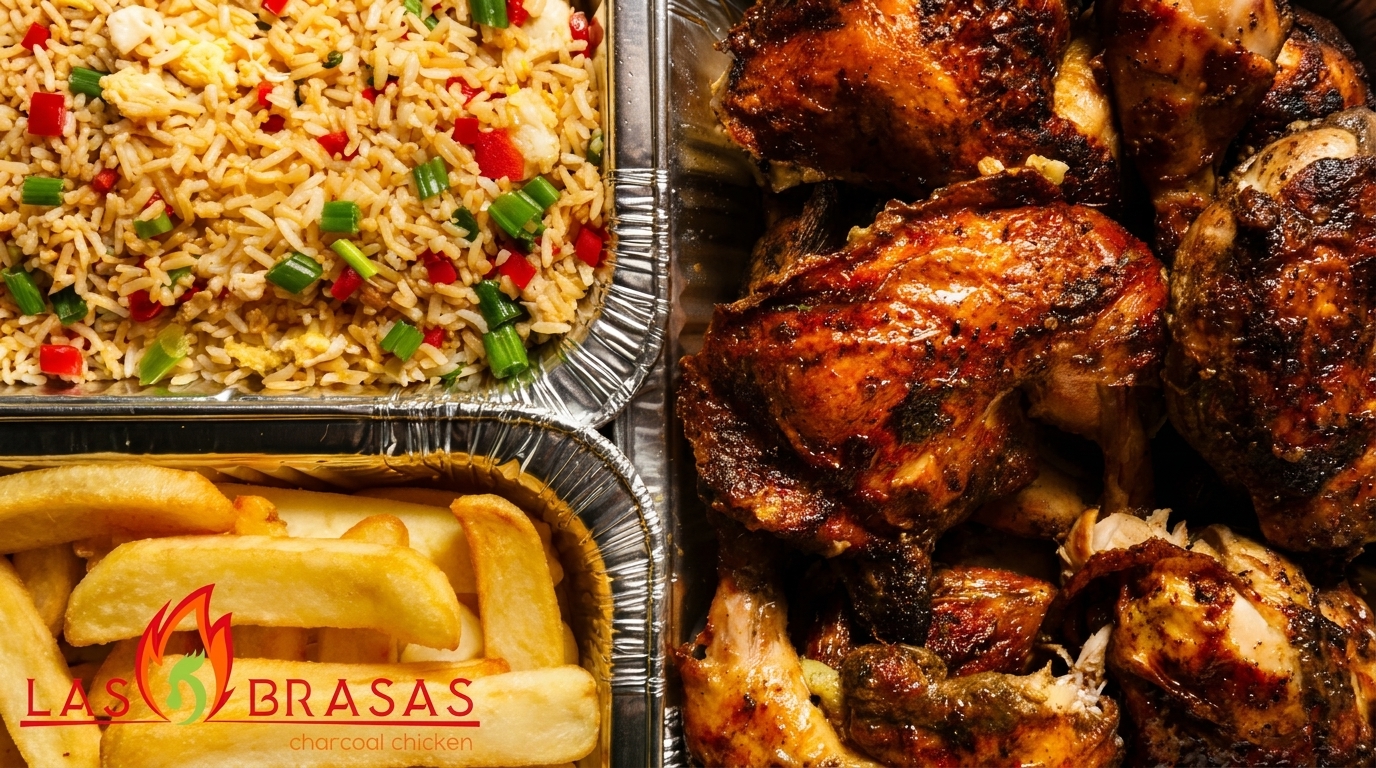 Las Brasas charcoal chicken, fried rice, and french fries in foil containers.