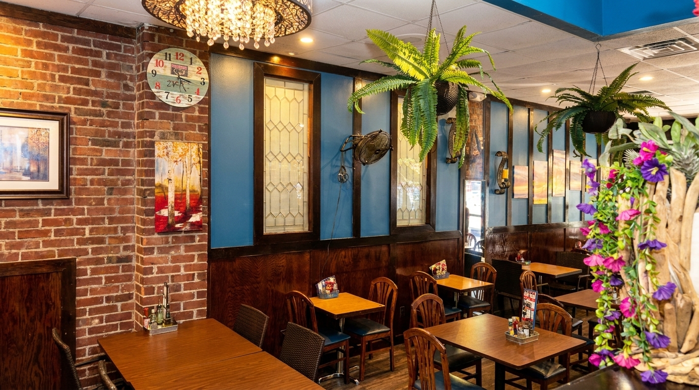 Cozy restaurant interior with brick walls, blue accents, wooden tables, and hanging plants.