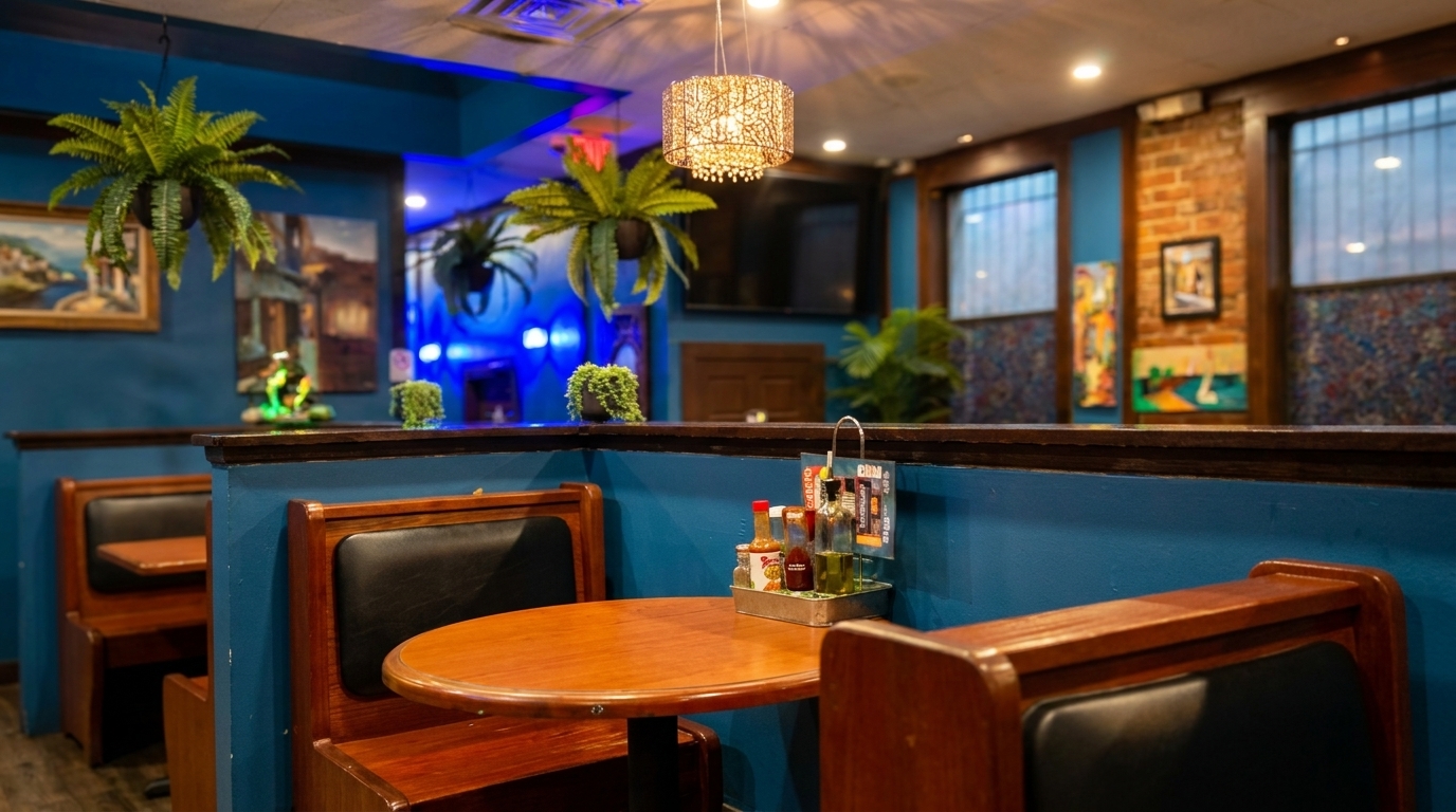 Cozy restaurant interior with blue walls, wooden booths, and a table set with condiments.