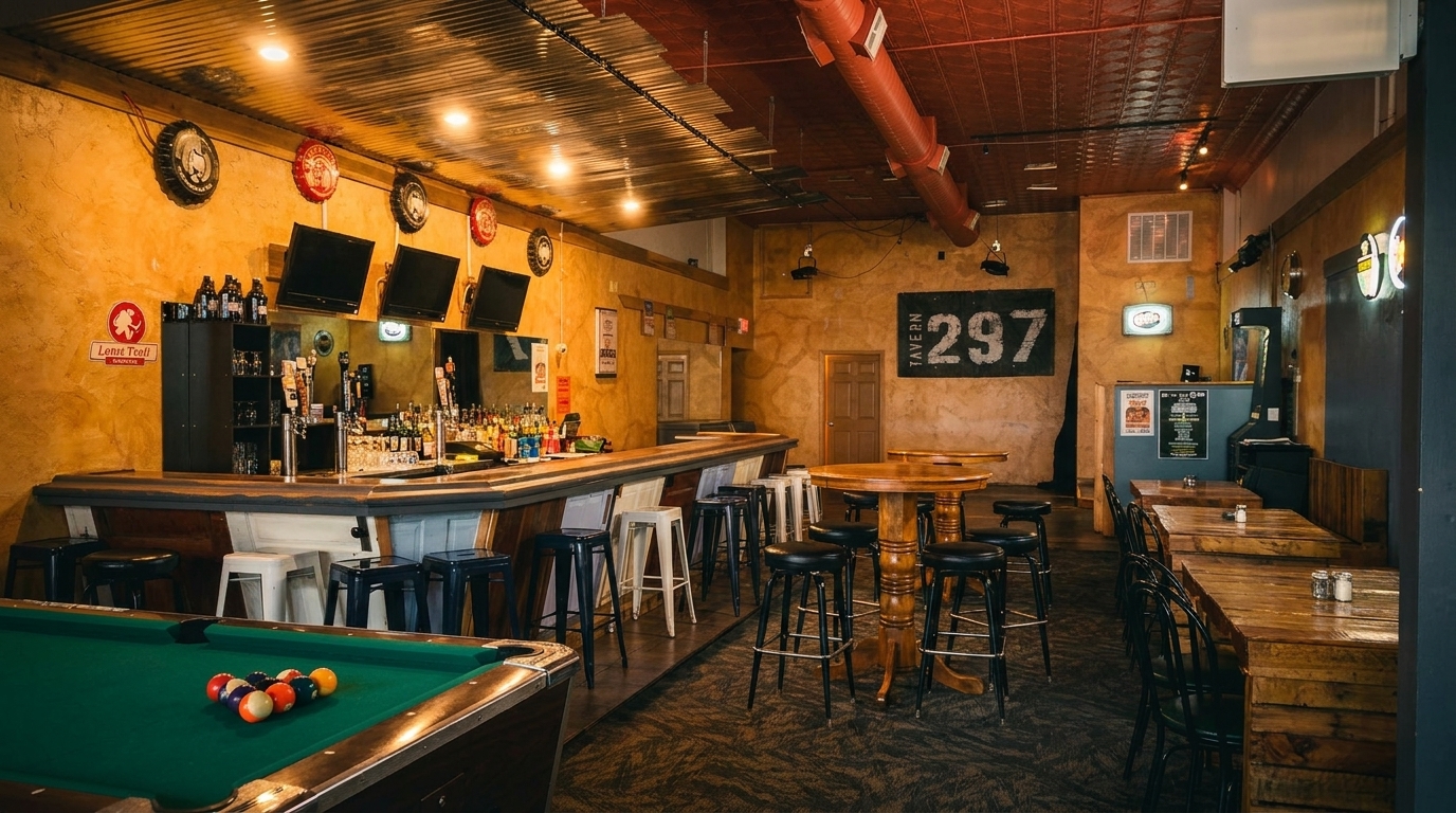 A rustic tavern interior with a long bar, high-top tables, and a pool table.