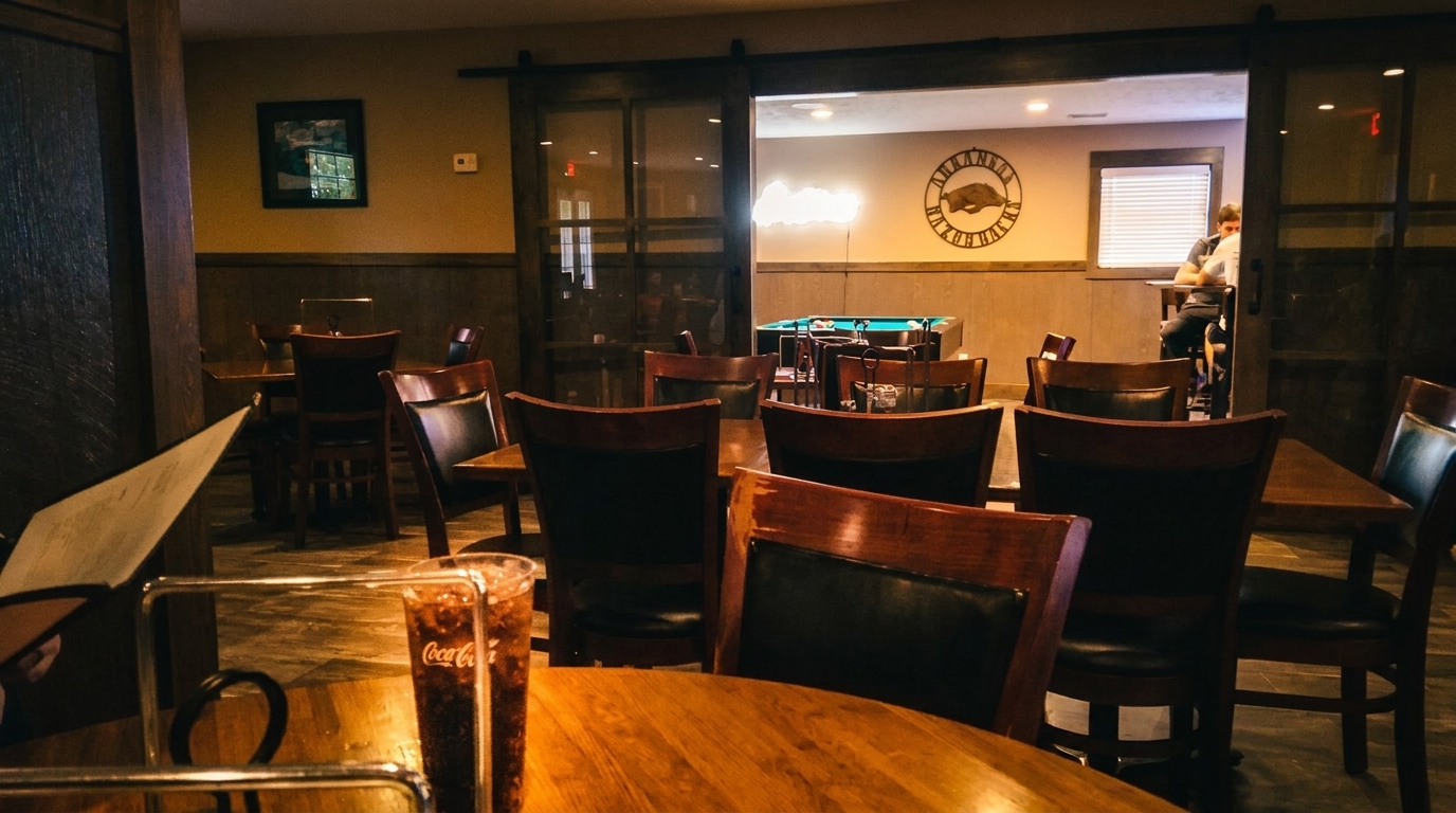 Restaurant dining area with wooden tables and chairs, a menu, and a Coca-Cola drink.