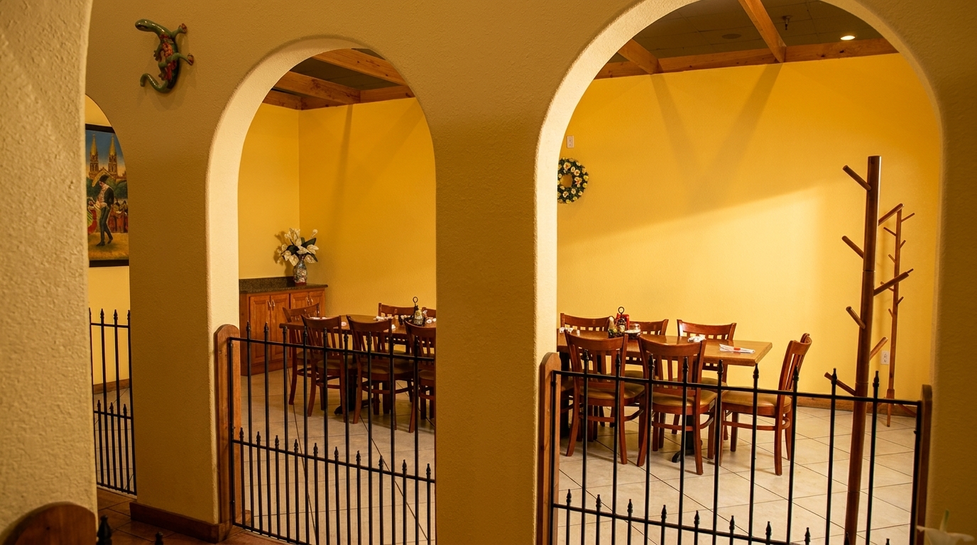 Arched doorways lead into a restaurant dining area with yellow walls and wooden tables and chairs.