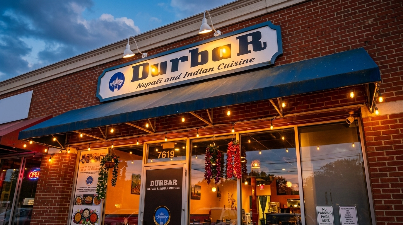 Durbar Nepali and Indian Cuisine restaurant exterior at dusk, with illuminated sign and string lights.