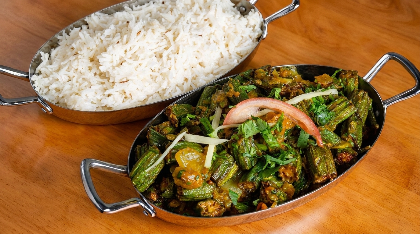 Indian dish of bhindi masala with okra, tomato, and cilantro, served with a side of basmati rice.