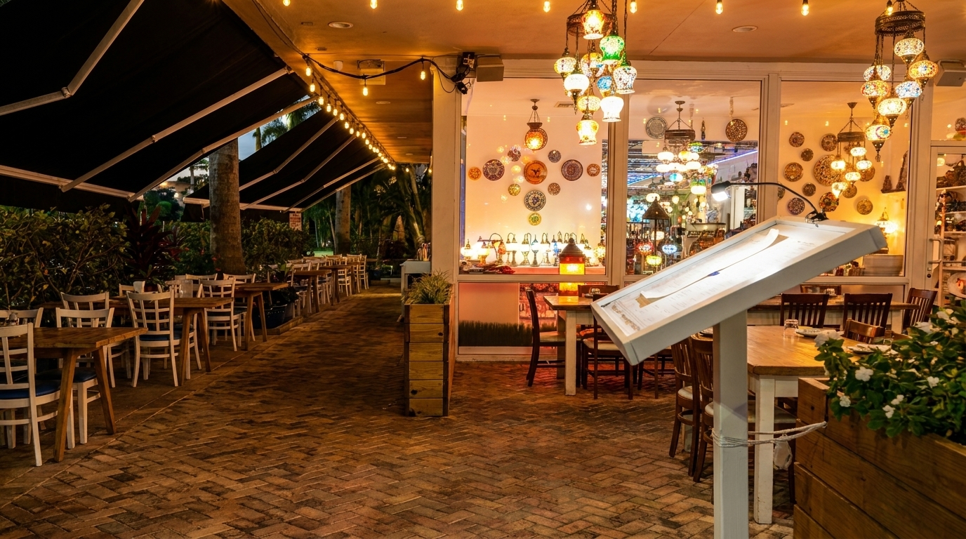 An outdoor patio dining area with string lights and a brightly lit interior with decorative lamps.