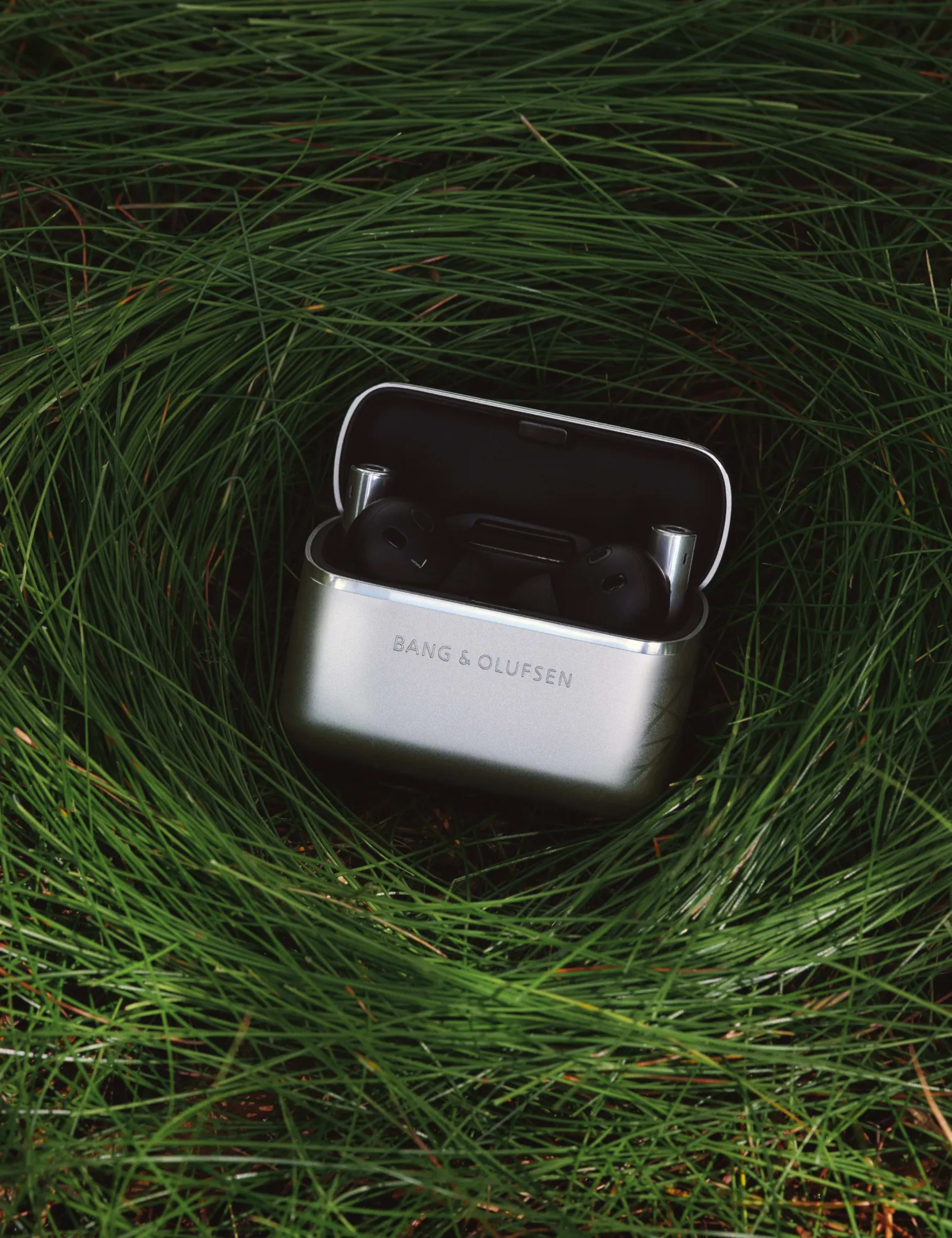Super Hoodie Charging case opened, showing the essentials inside on the grass