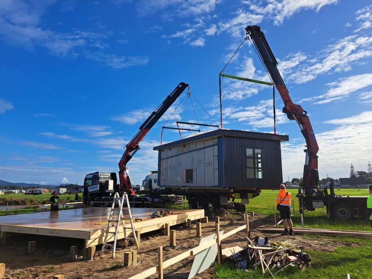Home module being lifted during site installation