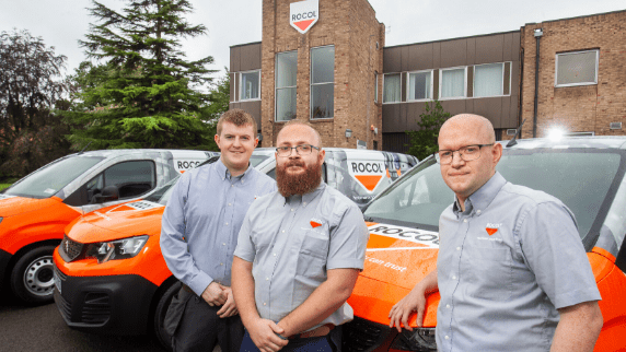 Three ROCOL metalworking service engineers stood in front of their service vans