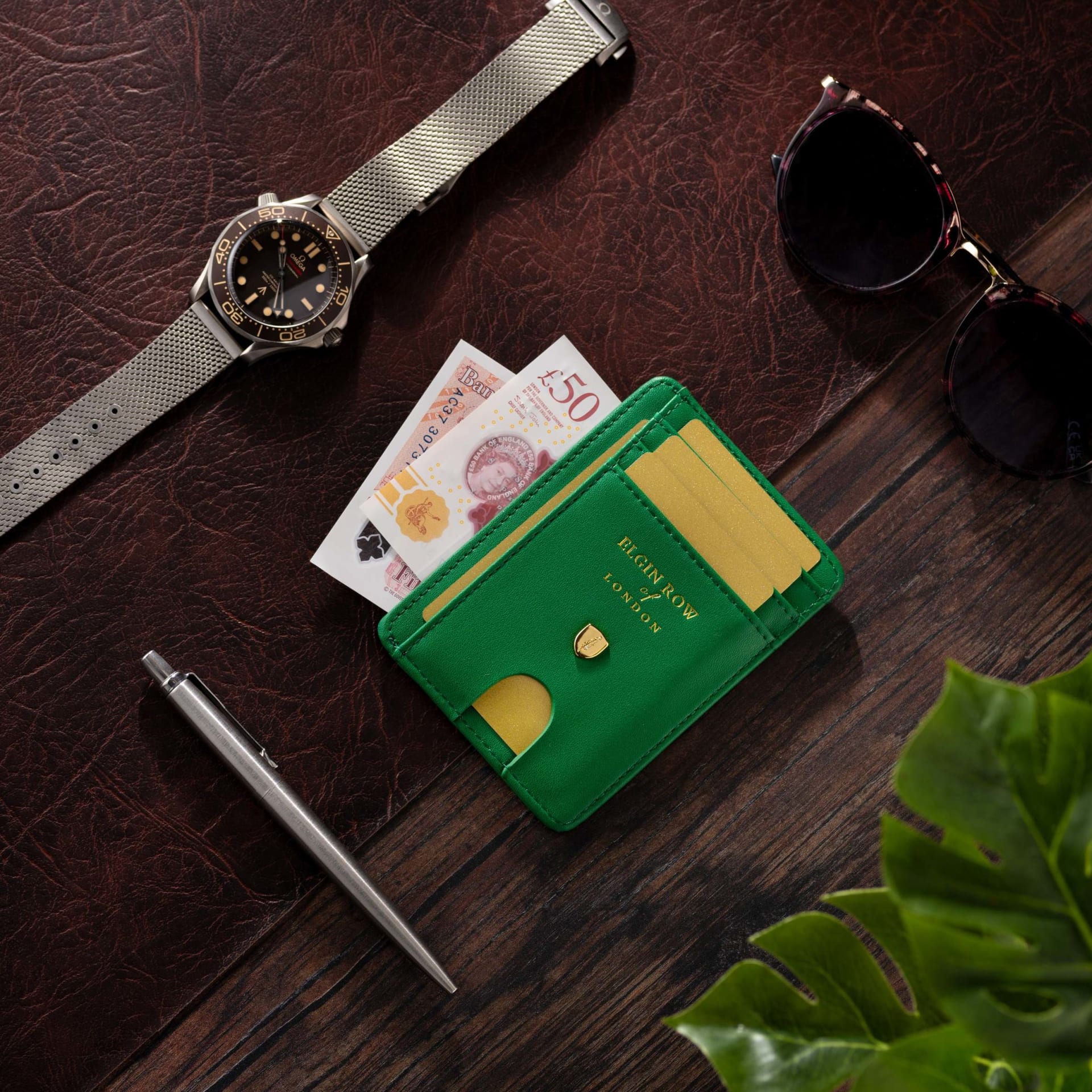 Green leather card holder wallet flat lay lifestyle - product photography UK