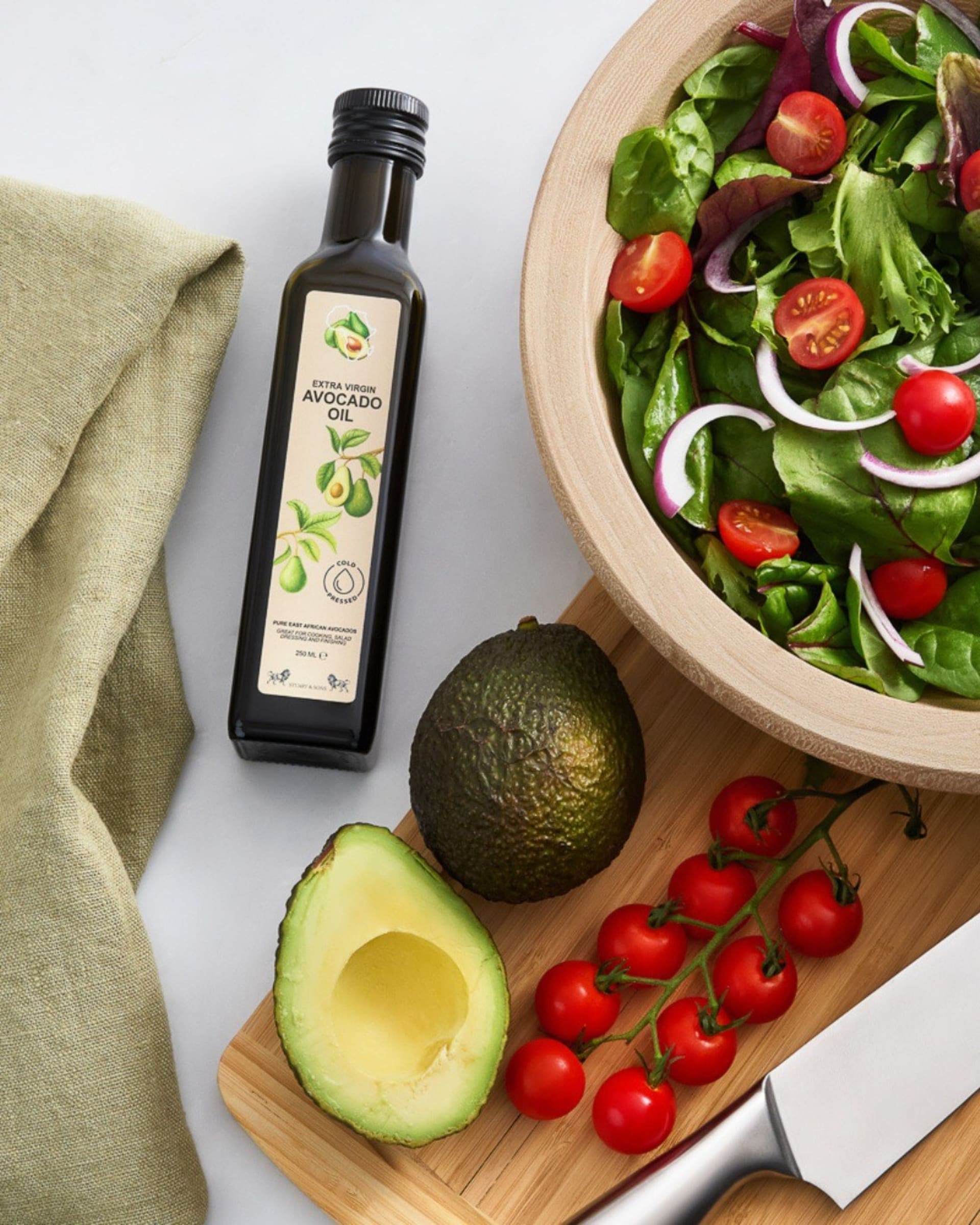 Avocado oil bottle with salad lifestyle flat lay - product photography UK