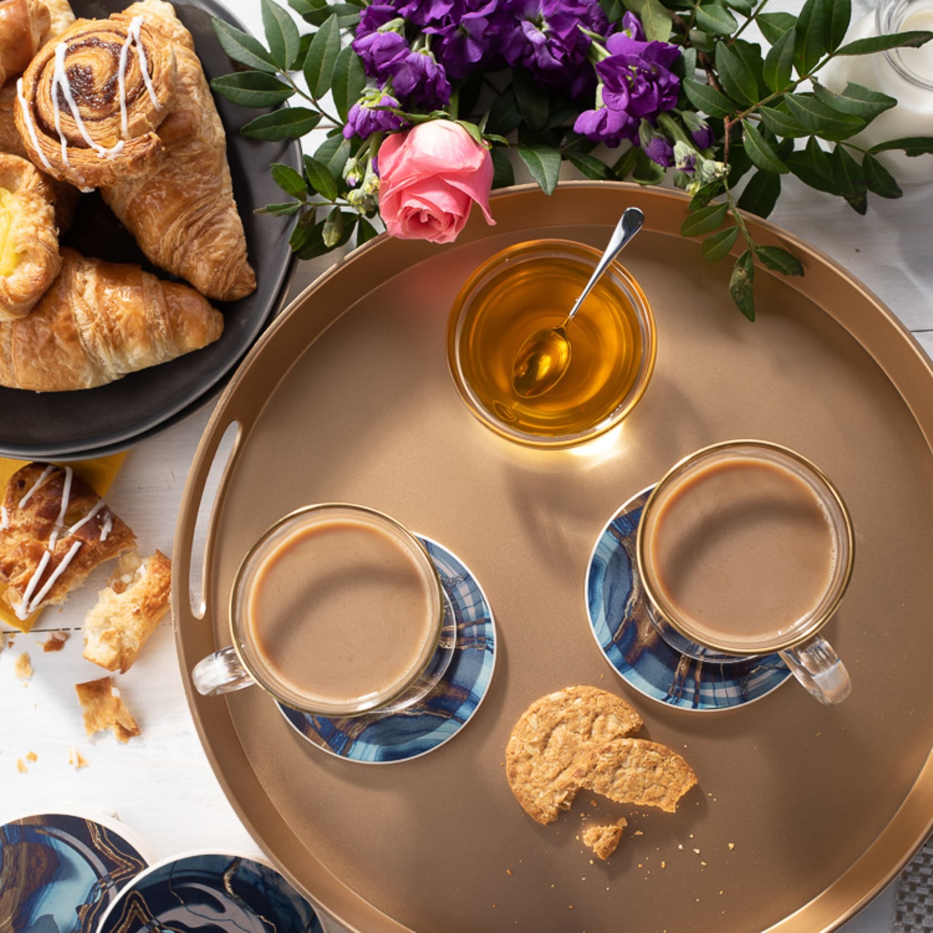 Coffee and pastries breakfast flat lay on gold tray - product photography UK