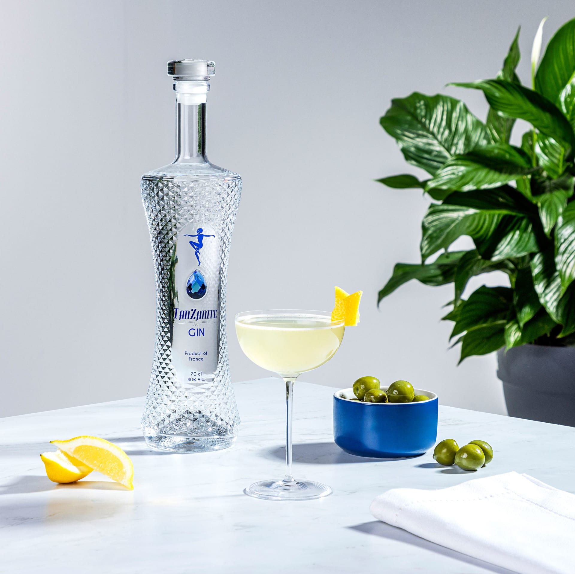 Gin bottle styled in a cocktail lifestyle scene
