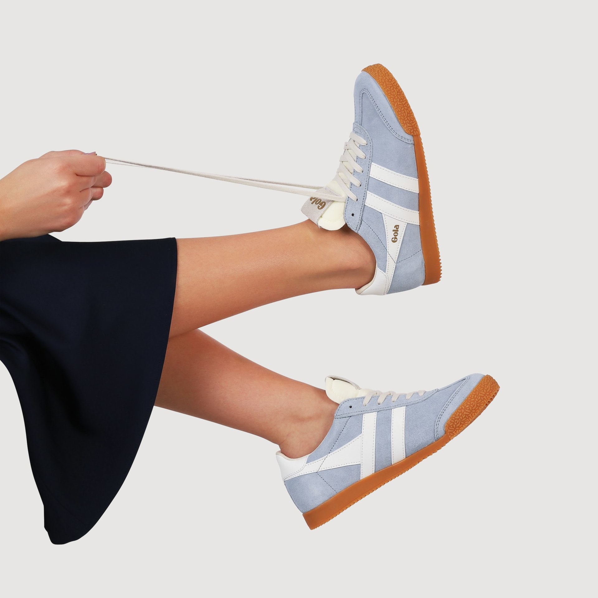 Gola blue suede trainers with gum sole on model lifestyle - footwear product photography UK