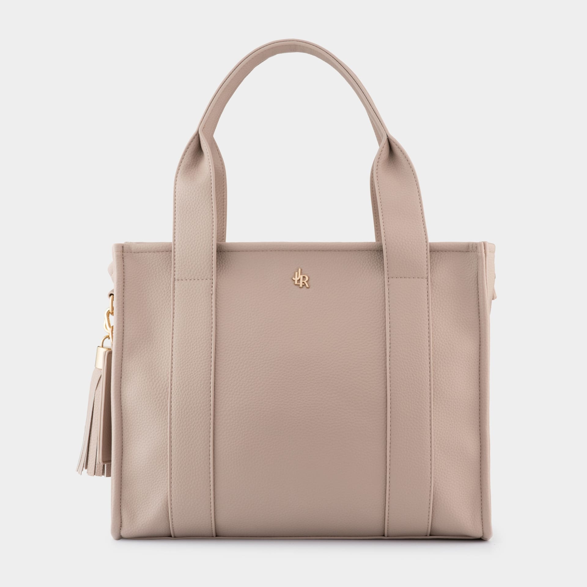 Blush pink leather tote bag with tassel packshot - product photography UK